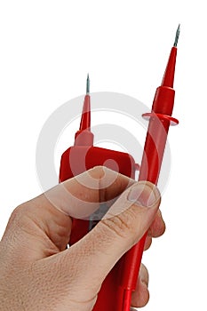 Red compact electric live voltage detector with needle shaped probes, one probe detached from the body, held in left hand