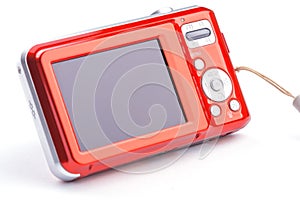 Red compact zoom digital camera over white