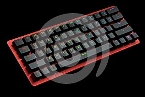 Red computer keyboard with rgb colors isolated on black background.