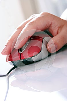 Red computer mouse and hand