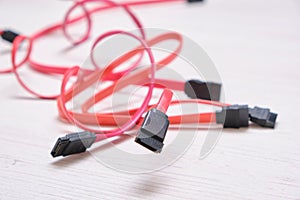 Red computer wires for hard drive on light background