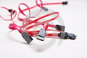 Red computer wires for hard drive on light background