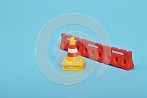 Red cone and Red safety barricades isolated on a blue background