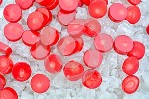 Red Coral Beads on Crystals of Bath Sea Salt for Spa as Summer background