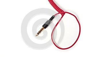 Red cord with a jack for connecting various gadgets, shot on a white background