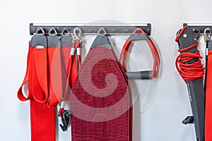 Red cord slings for therapeutic exercises and neuromuscular activation.