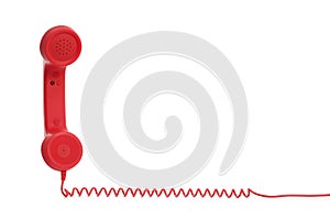 Red corded telephone handset on white background. Hotline concept