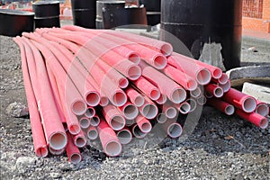 Red corrugated pipe for wire at construction site. Cable conduit for trenchless installations