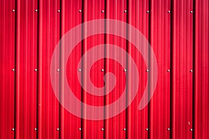 Red corrugated tin blank background with rivets.