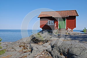 Red cottage on a cliff