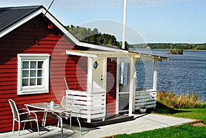 Red cottage by lake