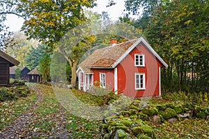 Red cottage in a village in the countryside