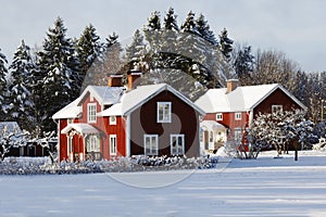 Red cottages, farm in snowy winter scenery