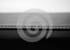 Red cotton on black leather texture background