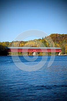 Red Covered Bridge with Colorful Autumn Foliage in Wakefield Quebec, Canada