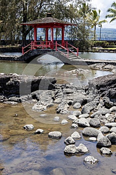 Red covered bridge at the park in Hilo