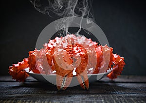 Red crab hokkaido - Alaskan king crab cooked steam or boiled seafood on dark background