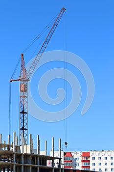 Red crane and part of building under construction