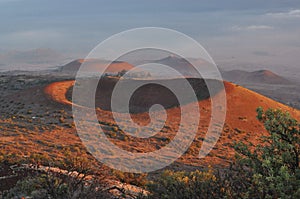 Red craters of Mauna Kea at sunset