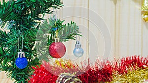 Red crismas ball on tree on wooden background