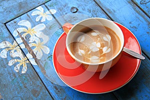 Red cup of coffee with heart and flower painted on foam