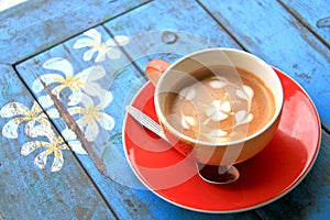 Red cup of coffee with heart and flower painted on foam