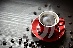 Red cup coffee with stream vapor and coffee bean on wood table, selective focus on edge of cup, Drinking concept