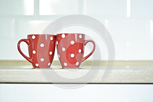 Red cup with dots on kitchen table