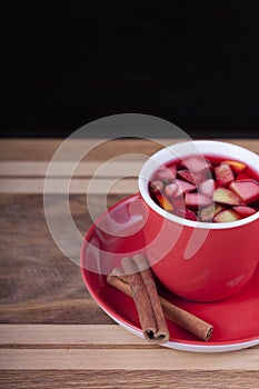 Red Cup with fruit tea on wooden background