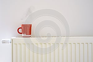 Red cup on the heating radiator