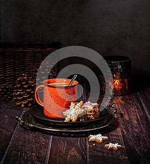 Red Cup of hot chocolate with Christmas cookies on rustic wood table