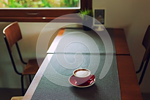 Red cup, Latte coffee heart shaped on wooden tablecloth