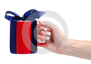 Red cup mug with blue ribbon bow gift in hand