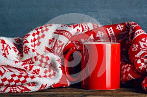 Red cup mug of tea coffee with warm winer plaid