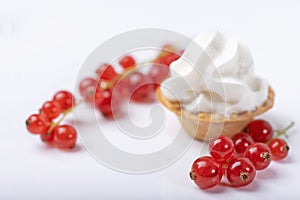 Red currant fresh berries and cream on white background