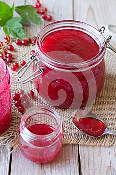 Red currant jam in glass jar