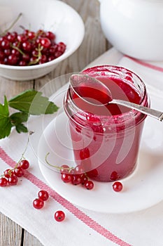 Red currant jam in glass jar