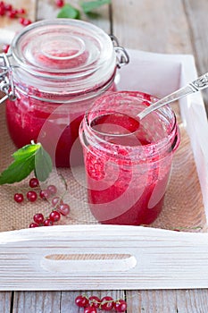 Red currant jam in glass jar