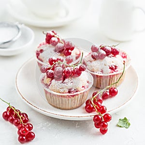 Red currant muffins with fresh berries and powdered sugar