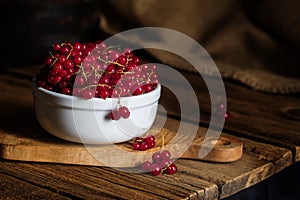 Red Currants in White Bowl on Wood Table