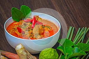 Red curry chicken, Thai Spicy food and fresh herb ingredients on wooden top view / still life, selective focus