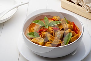 Red curry with clown featherback fishball in white bowl