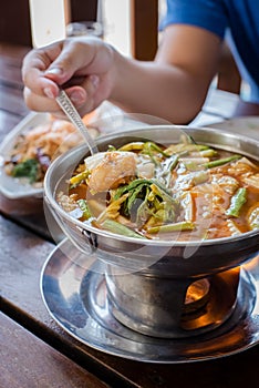 Red curry Giant catfish eggs with vegetable in sour soup.