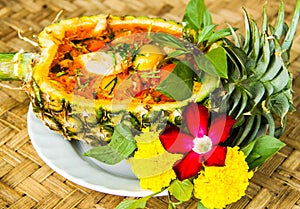 Red curry in pineapple bowl