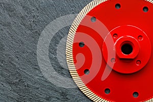 Red cutting diamond blade on a gray granite background