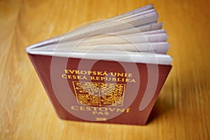 Red Czech passport on the wooden surface with a state symbol (lions and eagles)