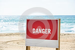 Red danger sign on an ocean beach