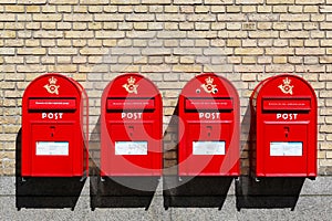 Red danish letterboxes on a wall