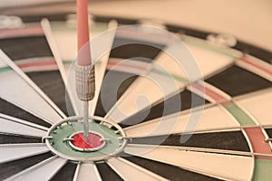 Red dart arrow hit the center bullseye dart board accuracy . Close up focus red circle compare strategy market of target success
