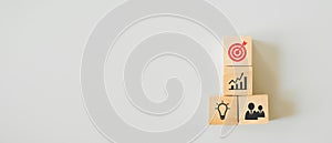 Red dartboard on wood cube on top of other business icons with copy space